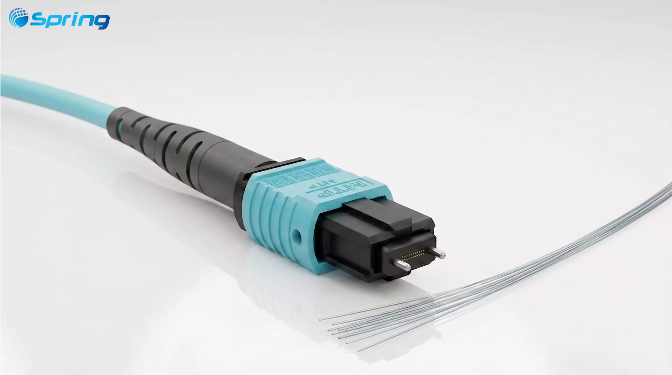 A close-up view of an aqua MTP connector (Multi-Fiber Termination Push-on), showing the precise alignment pins and an exposed ribbon of multiple optical fibers.